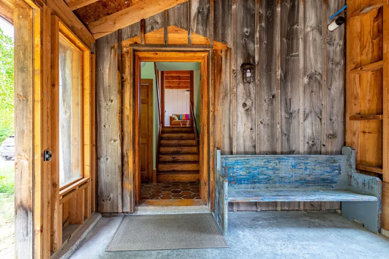 Entryway Charm: Step into rustic elegance with a bright, welcoming space and vintage bench!
