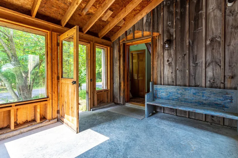 Entrance Hall: Bright and inviting with rustic wood accents and charming nature views!