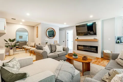 Living Room: Relax in style with plush seating and a modern fireplace for cozy evenings!