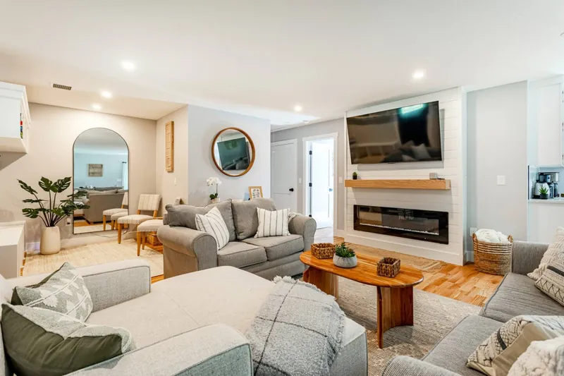 Living Room: Relax in style with plush seating and a modern fireplace for cozy evenings!