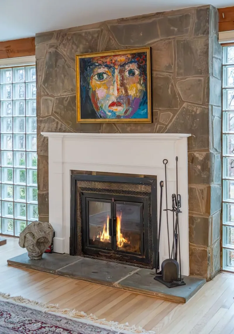 Living Room: Bright space with a stunning fireplace and vibrant artwork for a peaceful retreat!