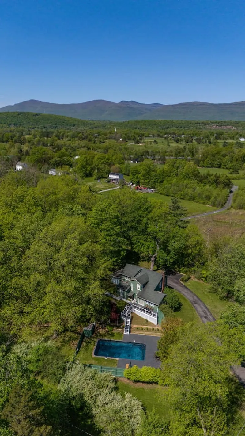 Aerial View: Enjoy breathtaking mountain views and a refreshing pool in serene Saugerties!