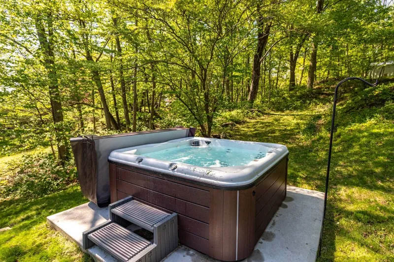Hot Tub Retreat: Soak in serenity surrounded by lush greenery and nature’s soundtrack!