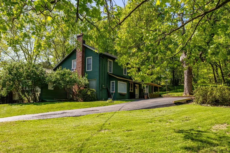 Charming Exterior: Embrace nature in this green retreat surrounded by lush greenery and tranquility!