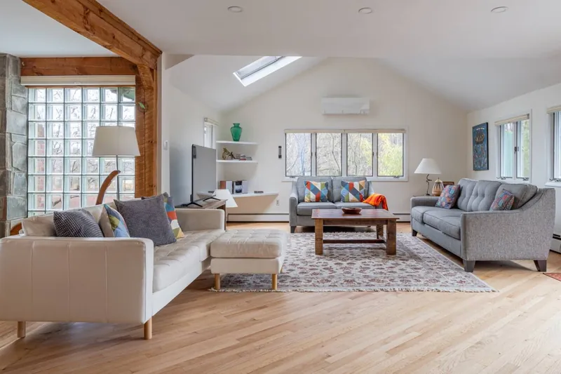 Living Room: Sun-soaked space with stylish seating and a charming view, perfect for relaxation