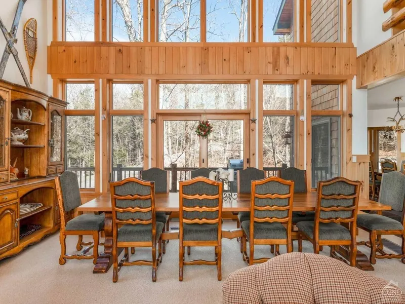 Dining Room: Gather around the rustic table with stunning views and natural light flooding in!