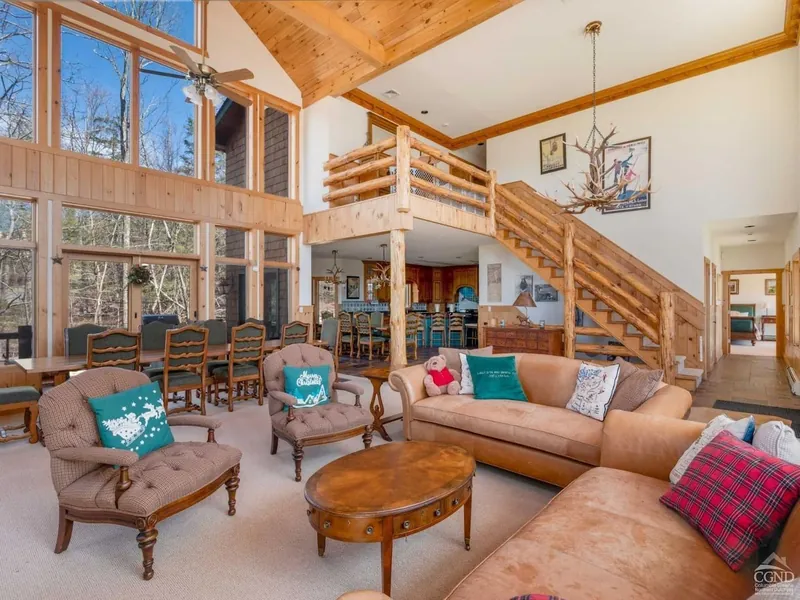Living Room Retreat: Sunlit space with stunning views, crafted wood accents, and inviting seating!