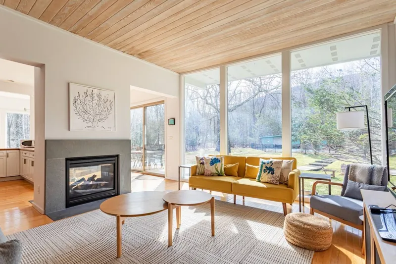 Living room with double-sided fireplace and floor-to-ceiling windows