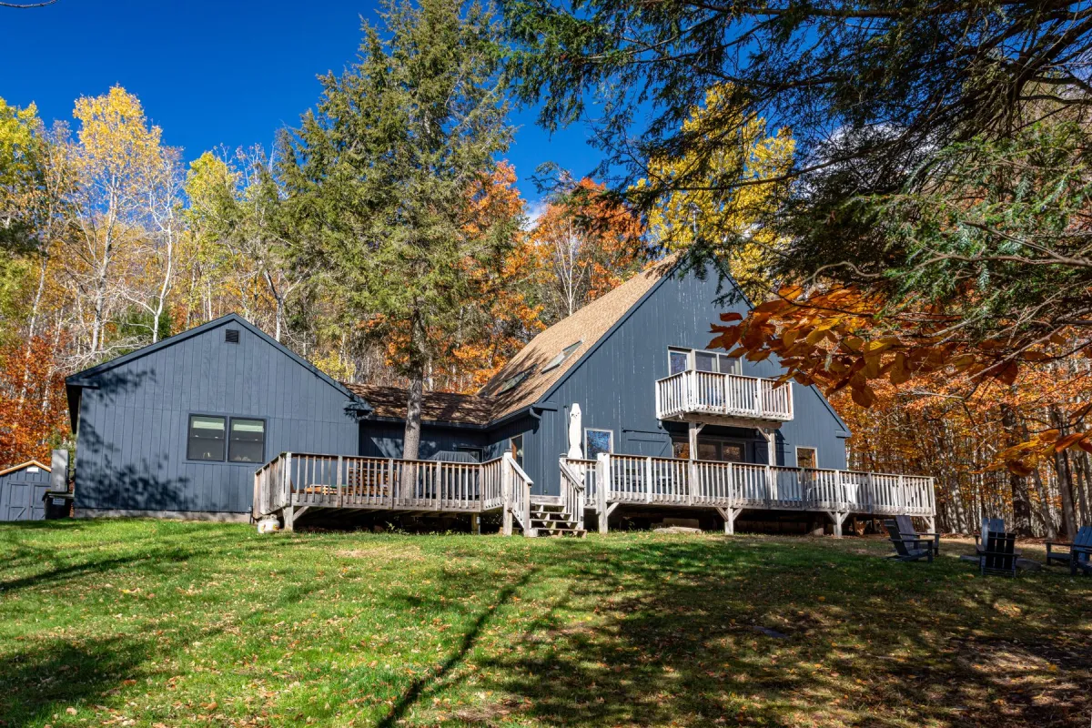 Blackberry Cottage, a gray A-frame in the autumn Catskills at Jewett, New York