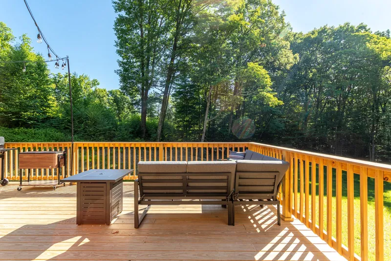 The deck and fire pit at Cherrytown Chalet, a Haus-managed home in Kerhonkson